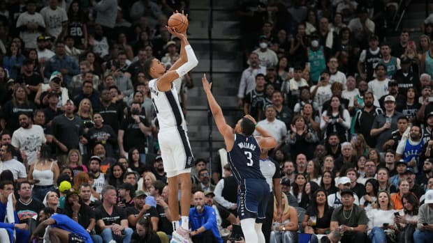 Oct 25, 2023; San Antonio, Texas, USA; San Antonio Spurs center Victor Wembanyama (1) shoots over Dallas Mavericks forward Grant Williams (3) in the second half at the Frost Bank Center. 